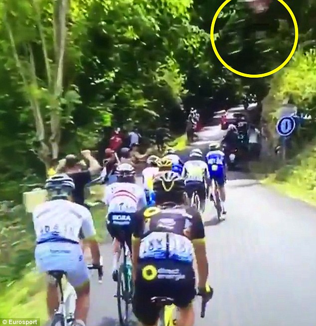 Mountain biker performs daring jump OVER Tour de France riders as they race up Alpine summit during stage 10