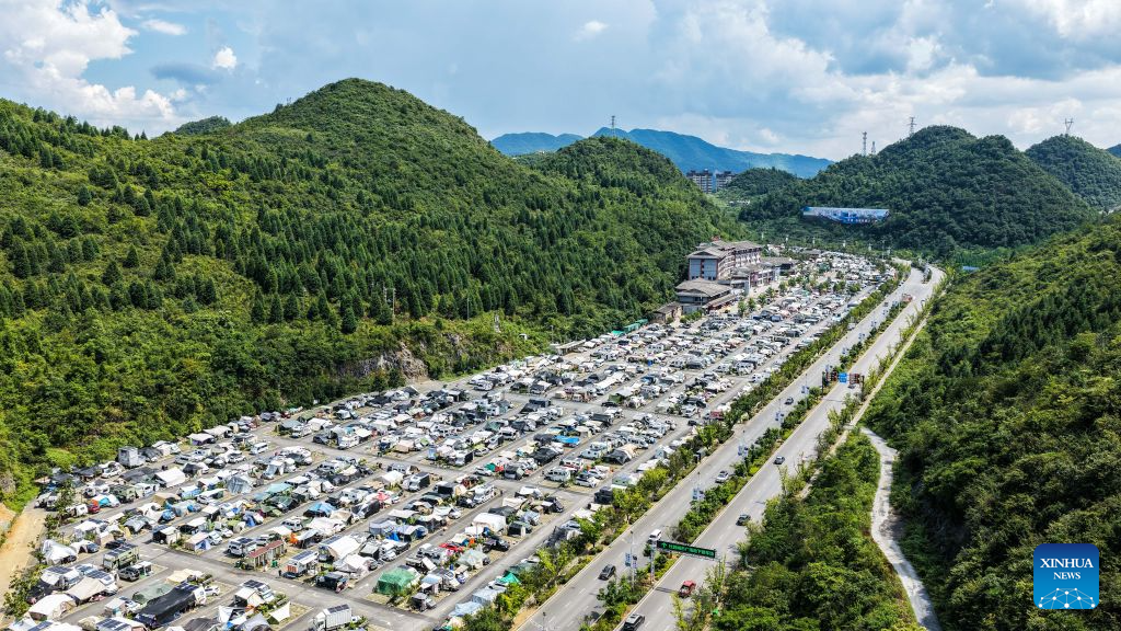 77db45b9679d46e0aa21e50ee08586d0.jpg An aerial drone photo shows RVs from across the country parking at an RV camping base in Bijie, southwest China's Guizhou Province, Aug. 11, 2026. The cool climate and rich tourism resources in Guizhou have attracted lots of visitors seeking a summer retreat. (Xinhua/Tao Liang)
